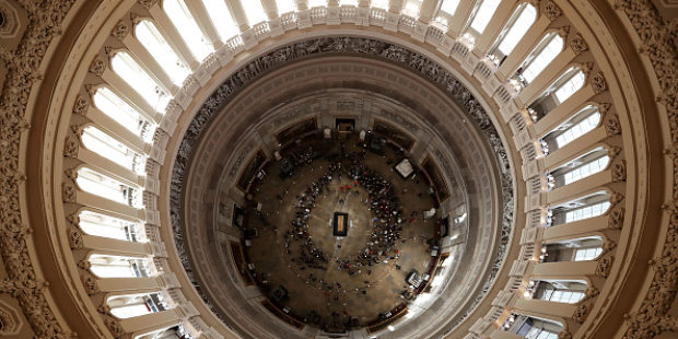 WASHINGTON, DC - FEBRUARY 28: Members of the public view Christian evangelist and Southern Baptist minister Billy Graham's casket as he lies in honor in the U.S. Capitol Rotunda February 28, 2018 in Washington, DC. A spiritual counselor for every president from Harry Truman to Barack Obama and other world leaders for more than 60 years, Graham died February 21 at the age of 99. (Chip Somodevilla/Getty Images)