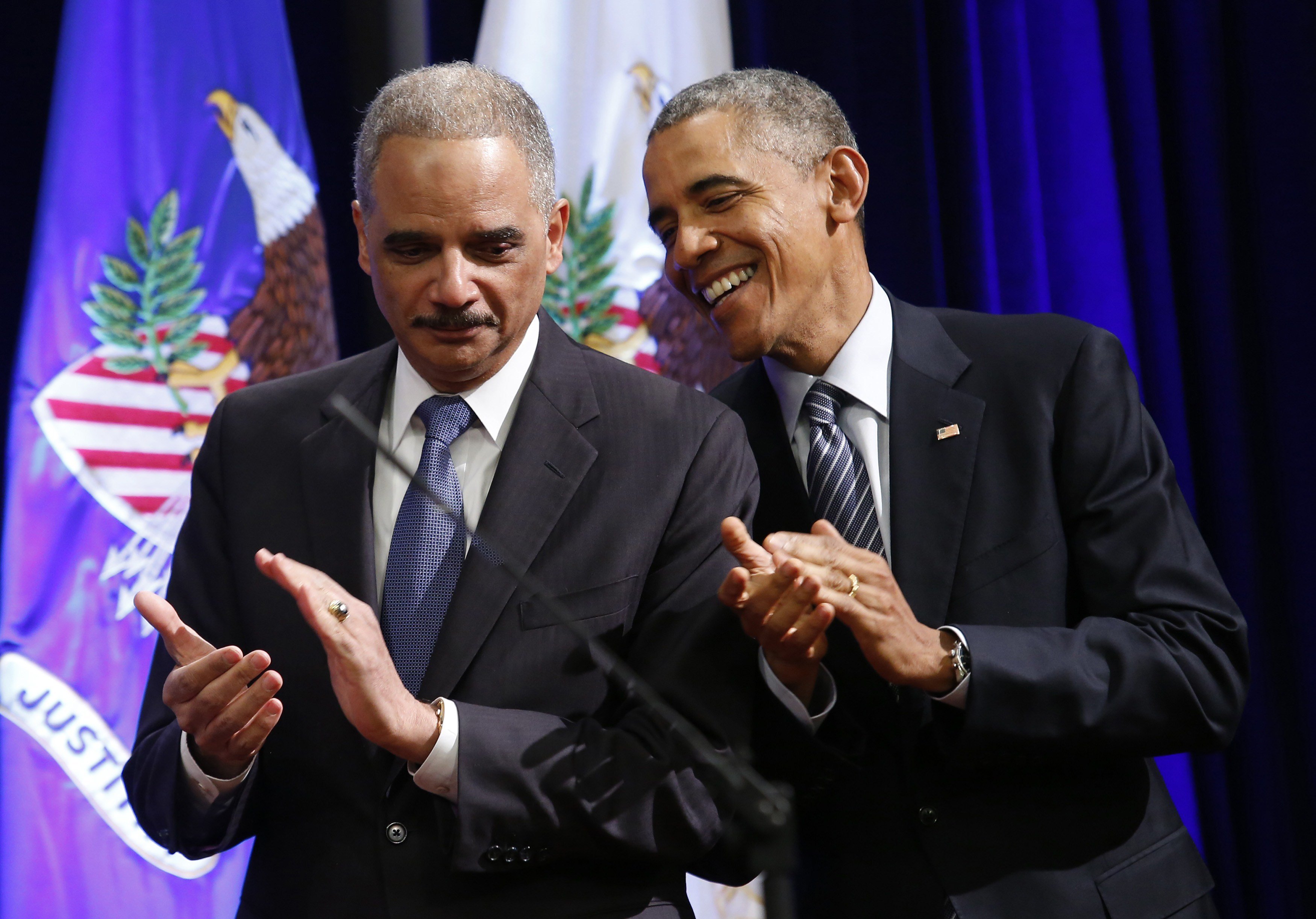 US President Barack Obama (R) talks to outgoing Attorney General Eric Holder at the portrait unveiling ceremony at the Justice Department in Washington, DC on February 27, 2015. The event marks Holder's anticipated departure after more than six years of service. (YURI GRIPAS/AFP/Getty Images)