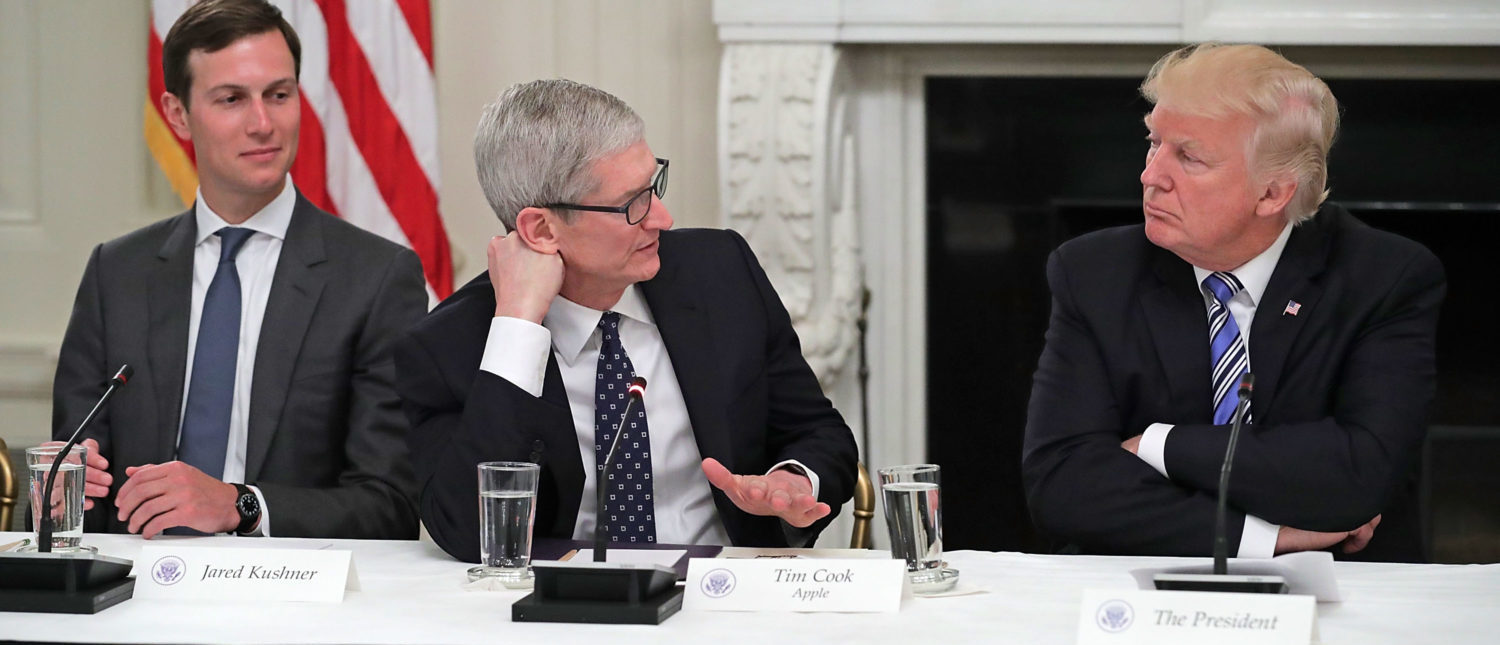 WASHINGTON, DC - JUNE 19:  Apple CEO Tim Cook delivers brief remarks as U.S. President Donald Trump (R) and White House Director of the Office of American Innovation and the president's son-in-law Jared Kushner listen during a meeting of the American Technology Council in the State Dining Room of the White House June 19, 2017 in Washington, DC. According to the White House, the council's goal is 