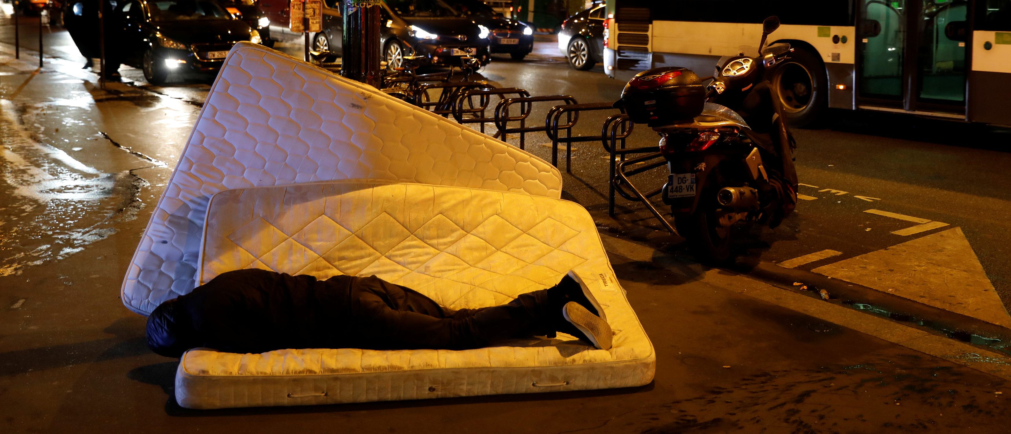 A man sleeps on a mattress next to the SCMR (Drug supervised injection site), the first supervised injection room for drug users, in Paris, October 17, 2016. REUTERS/Benoit Tessier