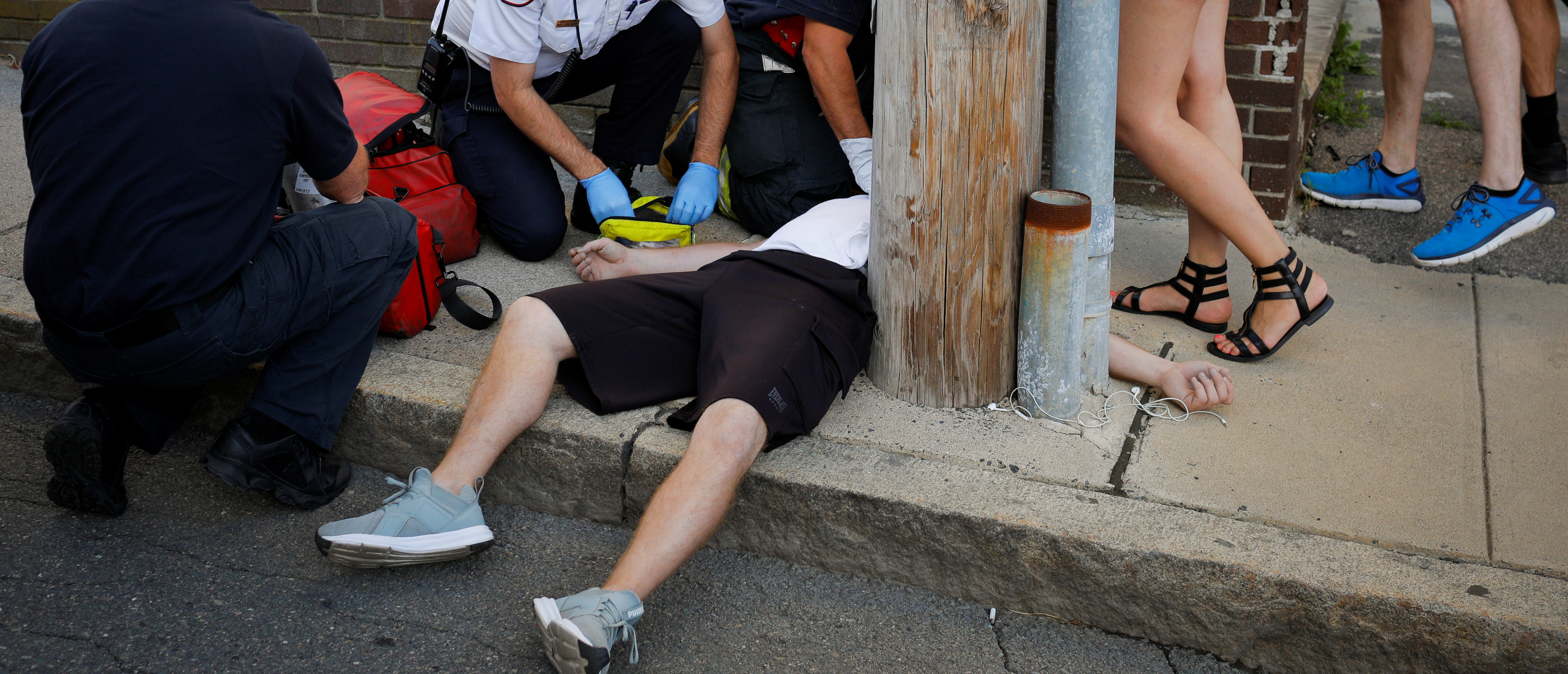 Cataldo Ambulance medics and other first responders revive a 32-year-old man who was found unresponsive and not breathing after an opioid overdose on a sidewalk in the Boston suburb of Everett, Massachusetts, U.S., August 23, 2017. REUTERS/Brian Snyder