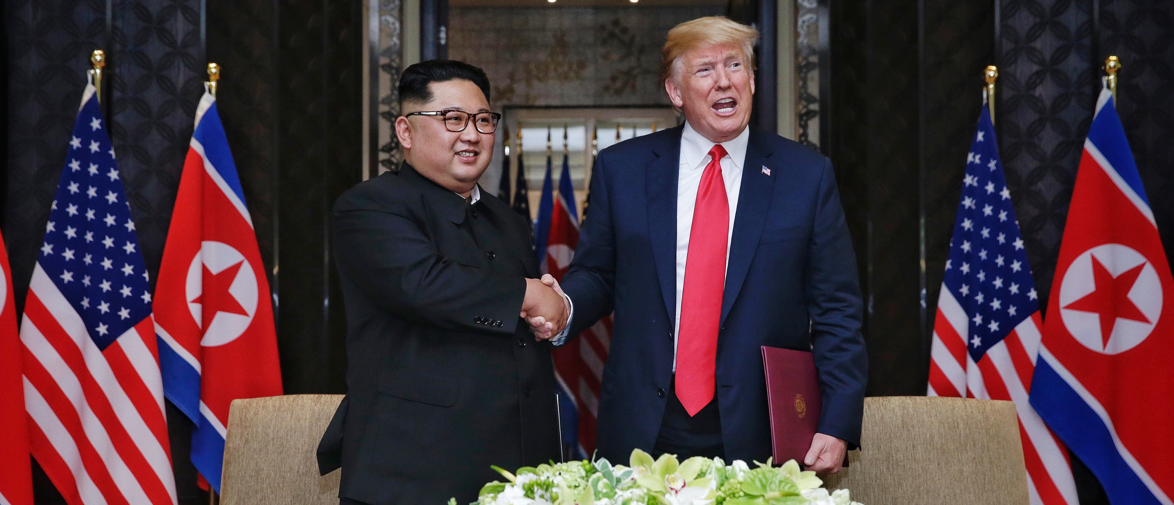 SINGAPORE, SINGAPORE - JUNE 12: In this handout photograph provided by The Strait Times, North Korean leader Kim Jong-un (L) with U.S. President Donald Trump (R) during their historic U.S.-DPRK summit at the Capella Hotel on Sentosa island on June 12, 2018 in Singapore. U.S. President Trump and North Korean leader Kim Jong-un held the historic meeting between leaders of both countries on Tuesday morning in Singapore, carrying hopes to end decades of hostility and the threat of North Korea's nuclear programme. (Photo by Kevin Lim/The Strait Times/Handout/Getty Images)