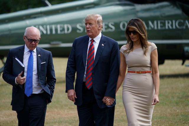 US Ambassador to the United Kingdom Woody Johnson (L) walks with US President Donald Trump (C) and US First Lady Melania Trump to the US ambassador's residence Winfield House in London on July 12, 2018. - The four-day trip, which will include talks with Prime Minister Theresa May, tea with Queen Elizabeth II and a private weekend in Scotland, is set to be greeted by a leftist-organised mass protest in London on Friday. (Photo credit: BRENDAN SMIALOWSKI/AFP/Getty Images)