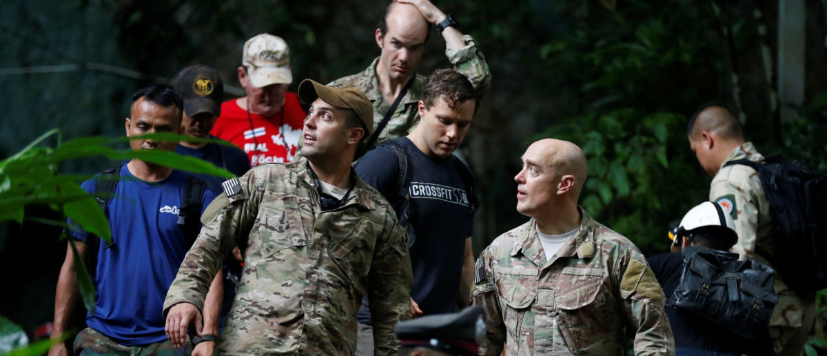 U.S. military personnel come out from Tham Luang cave complex during a search for members of an under-16 soccer team and their coach, in the northern province of Chiang Rai, Thailand, June 28, 2018. REUTERS/Soe Zeya Tun