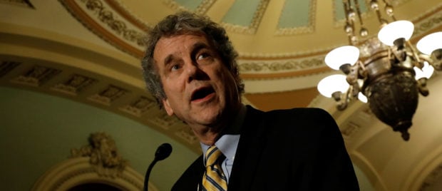 Senator Sherrod Brown (D-OH), accompanied by Senator Tammy Baldwin (D-WI), speaks with reporters following the party luncheons on Capitol Hill in Washington, U.S. December 5, 2017. REUTERS/Aaron P. Bernstein - RC1C4663D070