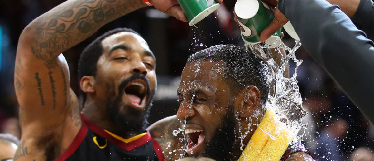 CLEVELAND, OH - APRIL 25: LeBron James #23 of the Cleveland Cavaliers is showered with water by JR Smith #5 while being interviewed after a 98-95 win over the Indiana Pacers in Game Five of the Eastern Conference Quarterfinals during the 2018 NBA Playoffs at Quicken Loans Arena on April 25, 2018 in Cleveland, Ohio. (Photo by Gregory Shamus/Getty Images)