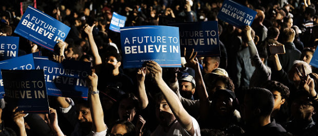 NEW YORK, NY - APRIL 18: People cheer as Democratic Presidential candidate Bernie Sanders walks on stage at a campaign rally on the eve of the New York primary, April 18, 2016 in the Queens borough of New York City. While Sanders is still behind in the delegate count with Hillary Clinton, he has energized many young and liberal voters around the country. New York holds its primary this Tuesday. (Photo by Spencer Platt/Getty Images)