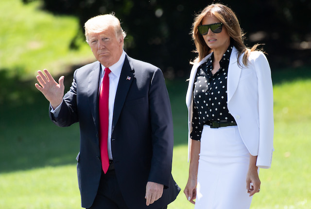 US President Donald Trump and First Lady Melania Trump walk to Marine One prior to departing from the South Lawn of the White House in Washington, DC, August 24, 2018, as they travel to Ohio. (Photo credit: SAUL LOEB/AFP/Getty Images)