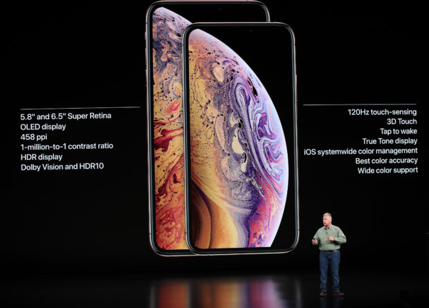 Phil Schiller, senior vice president of worldwide marketing at Apple Inc., describes the iPhone XS Max (left) and iPhone XS (right) at the iPhone release in Cupertino, California, on Sept. 12, 2018. Photo by Justin Sullivan/Getty Images