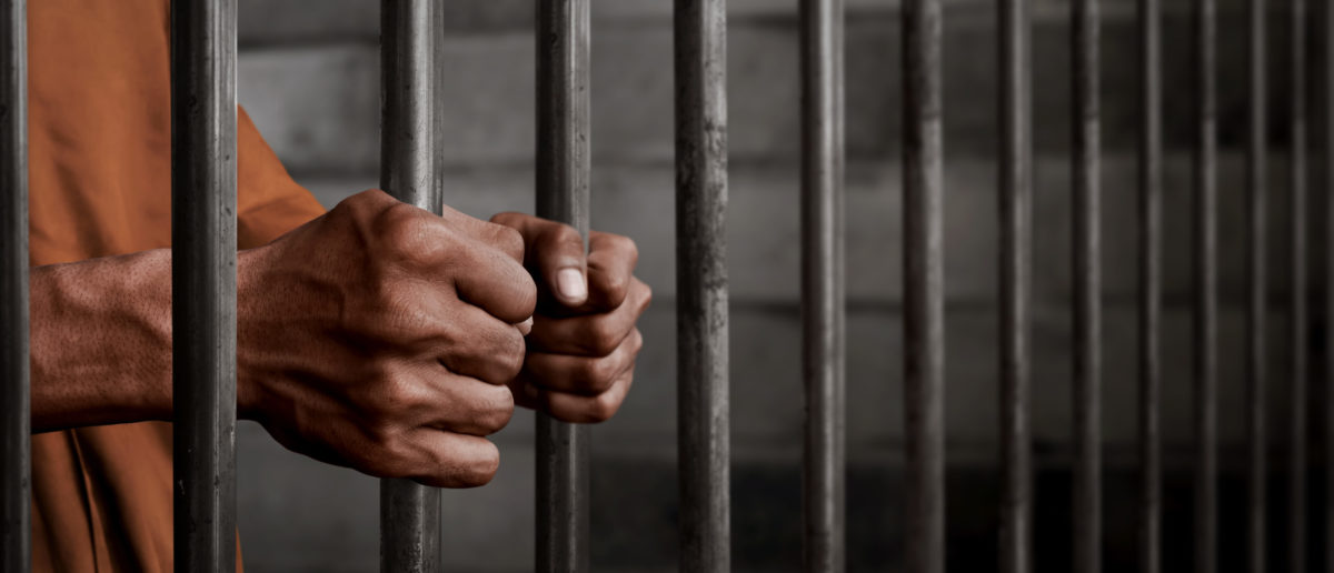Pictured is a man in jail. (Shutterstock/FOTOKITA)