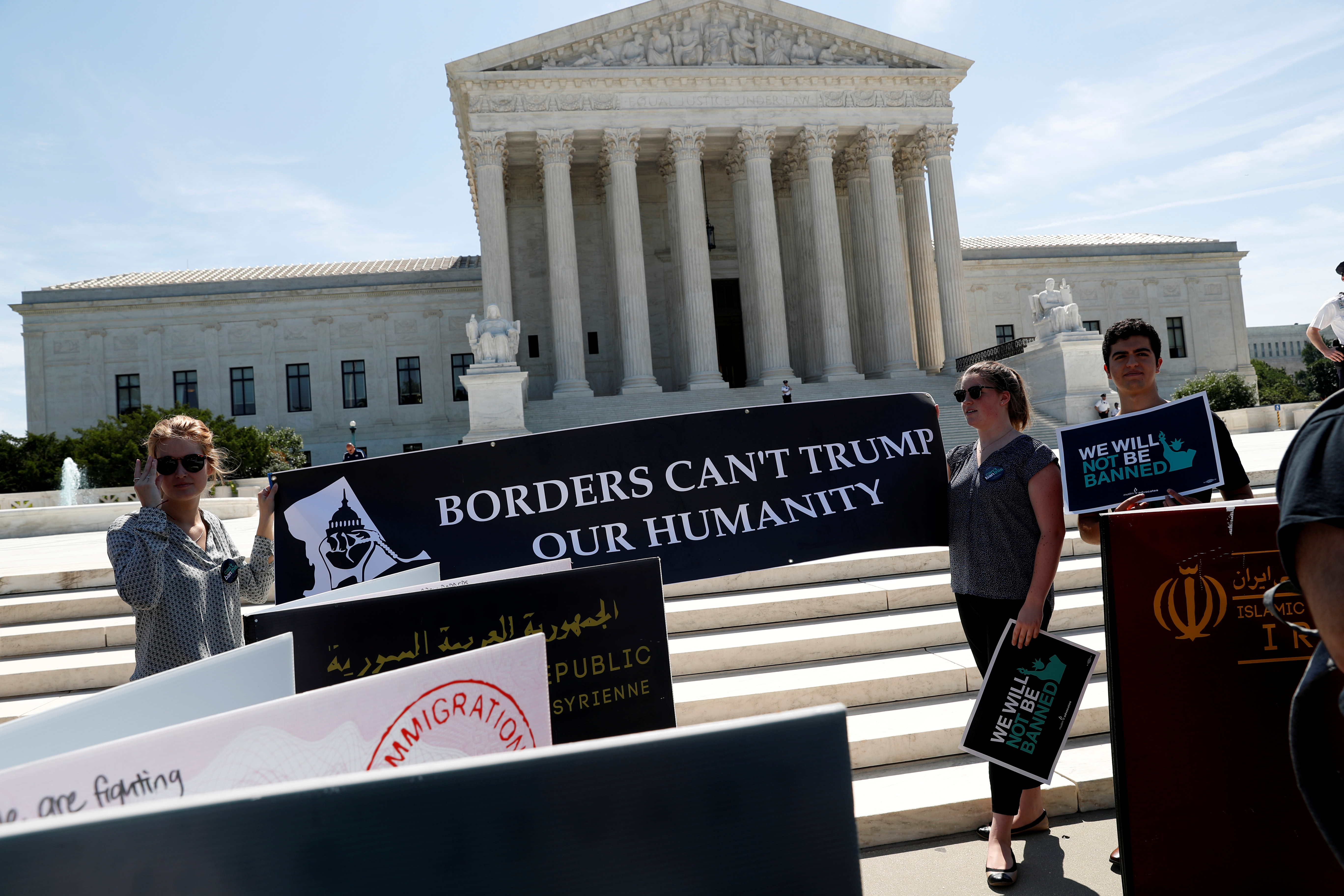 Immigration rights proponents demonstrate outside the U.S. Supreme Court in Washington, U.S., June 26, 2018. REUTERS/Leah Millis