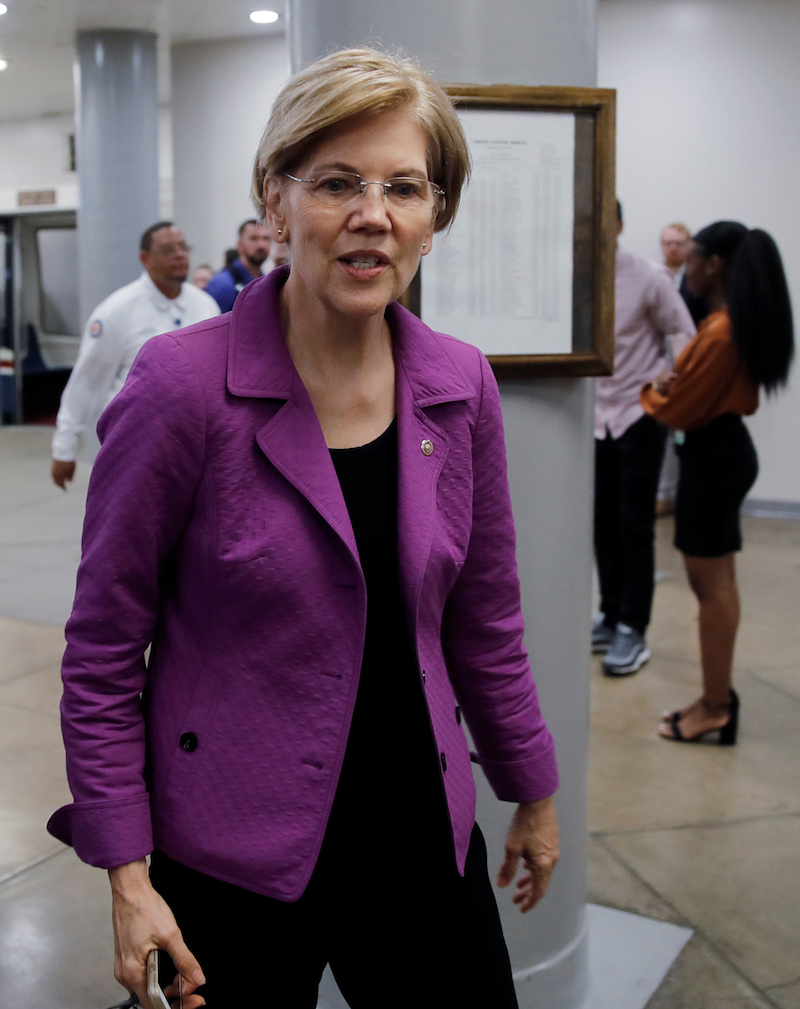 Senator Elizabeth Warren (D-MA), talks to reporters as she walks through the U.S. Senate subway on Capitol Hill in Washington, September 18, 2018. REUTERS/Mike Segar