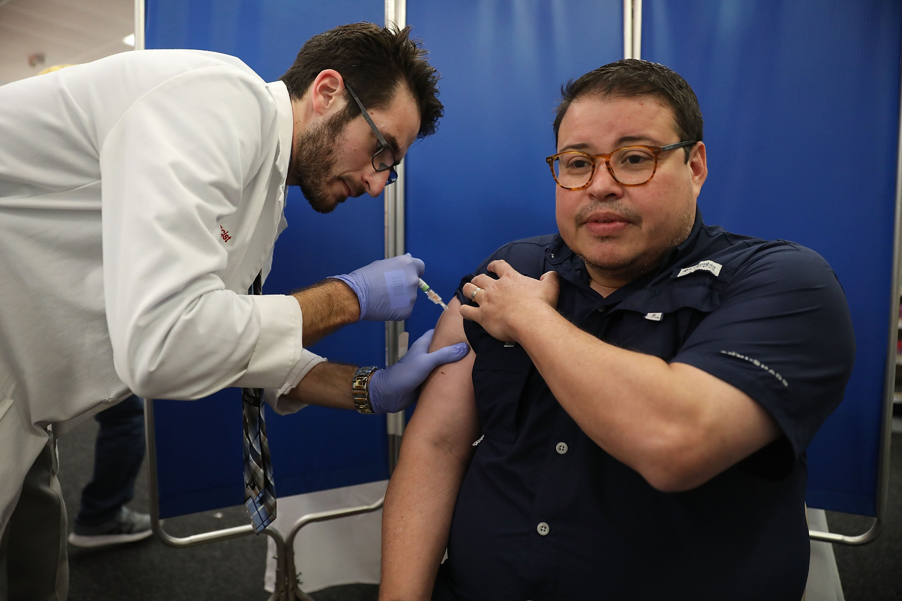 Mario Ancalmo receives an influenza vaccination from Raphael Lynne, Pharm. D., MBA, at the CVS/pharmacy on October 4, 2018 in Miami, Florida. Joe Raedle/Getty Images