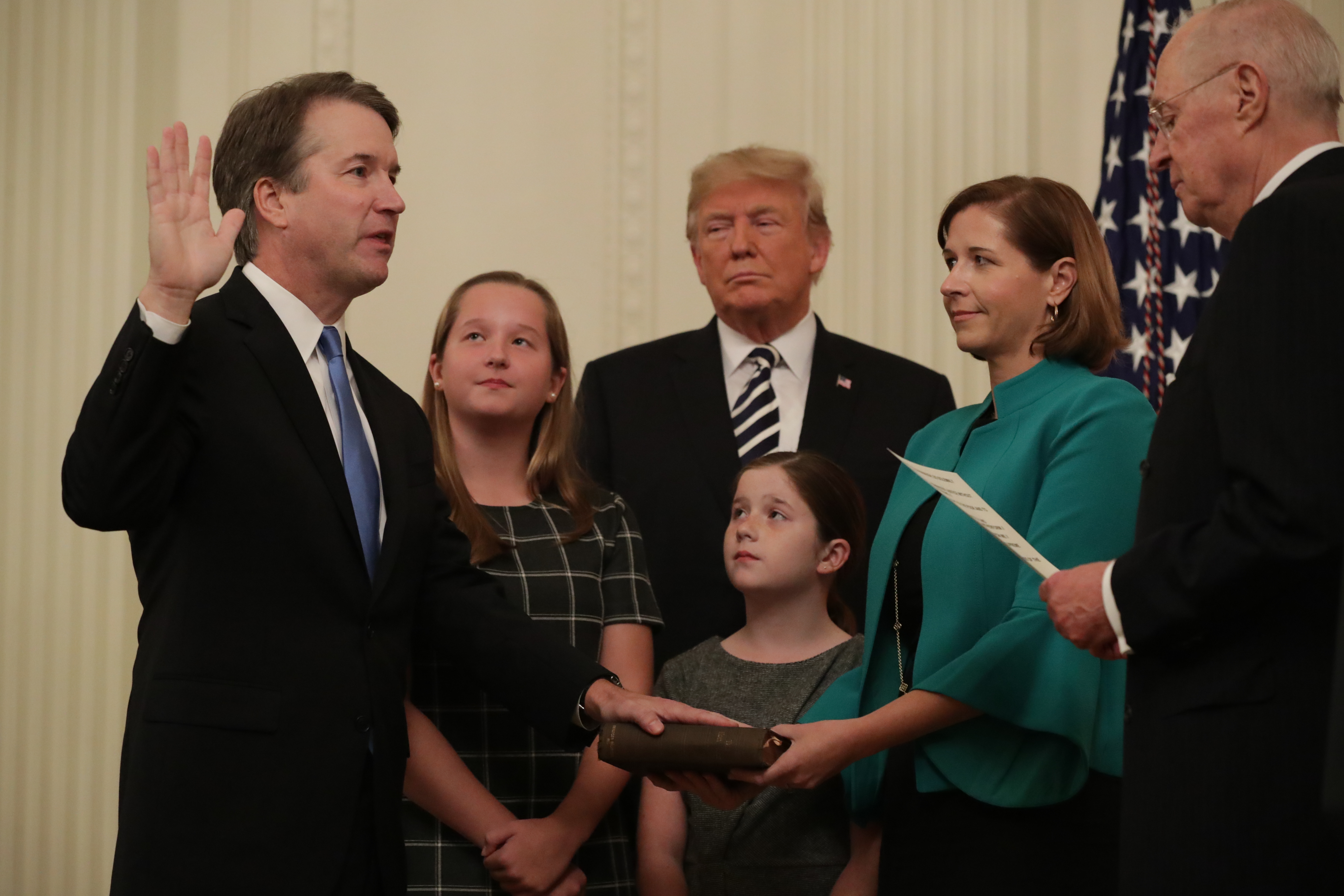 U.S. Supreme Court Justice Brett Kavanaugh (L) participates in a ceremonial swearing in by retired Justice Anthony Kennedy (R) as President Donald Trump, Kavanaugh's wife Ashley, youngest daughter Liza and oldest daughter Margaret look on in the East Room of the White House October 08, 2018 in Washington, DC. Chip Somodevilla/Getty Images