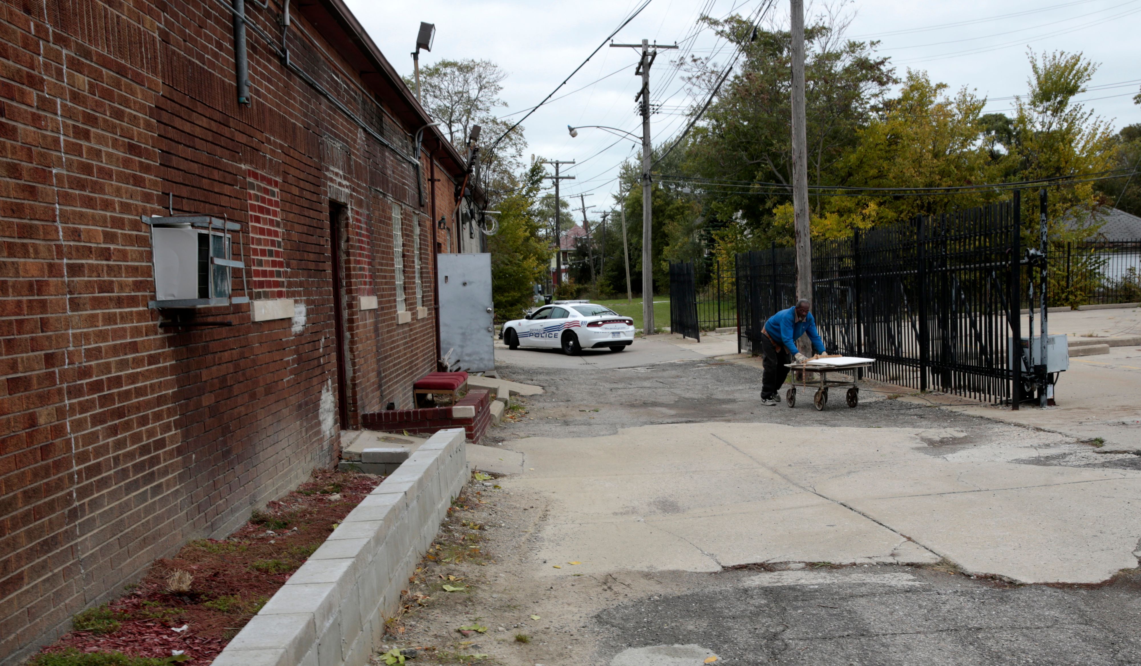 A unidentified person cleans out the closed Cantrell Funeral Home on Mack Avenue in Detroit on October 21, 2018. JEFF KOWALSKY/AFP/Getty Images