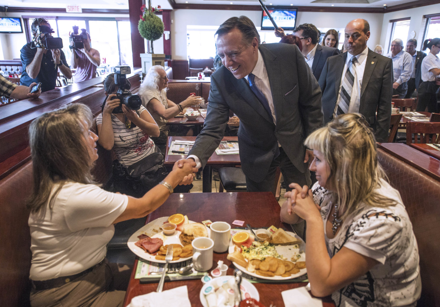 Coalition Avenir Quebec (CAQ) candidate Francois Legault greets diners during lunch with staffers after voting on September 4, 2012 in l'Assomption, Quebec, Canada.(ROGERIO BARBOSA/AFP/GettyImages)