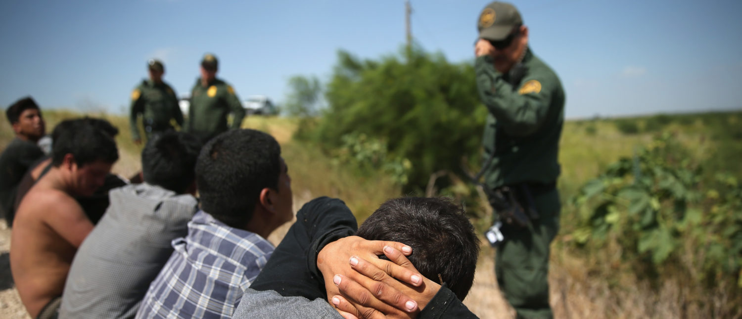 MCALLEN, TX - AUGUST 07: U.S. Border Patrol agents detain undocumented immigrants after they crossed the border from Mexico into the United States on August 7, 2015 in McAllen, Texas. The state's Rio Grande Valley corridor is the busiest illegal border crossing into the United States. Border security and immigration have become major issues in the U.S. presidential campaigns. (Photo by John Moore/Getty Images)