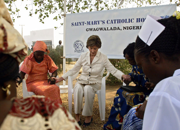 GWAGWALADA, NIGERIA: US First Lady Laura Bush (2nd L) prays with staff and HIV patients at St. Mary's Hospital in Gwagwalada, Nigeria, 18 January 2006. AFP PHOTO/Jim WATSON (Photo credit should read JIM WATSON/AFP/Getty Images)
