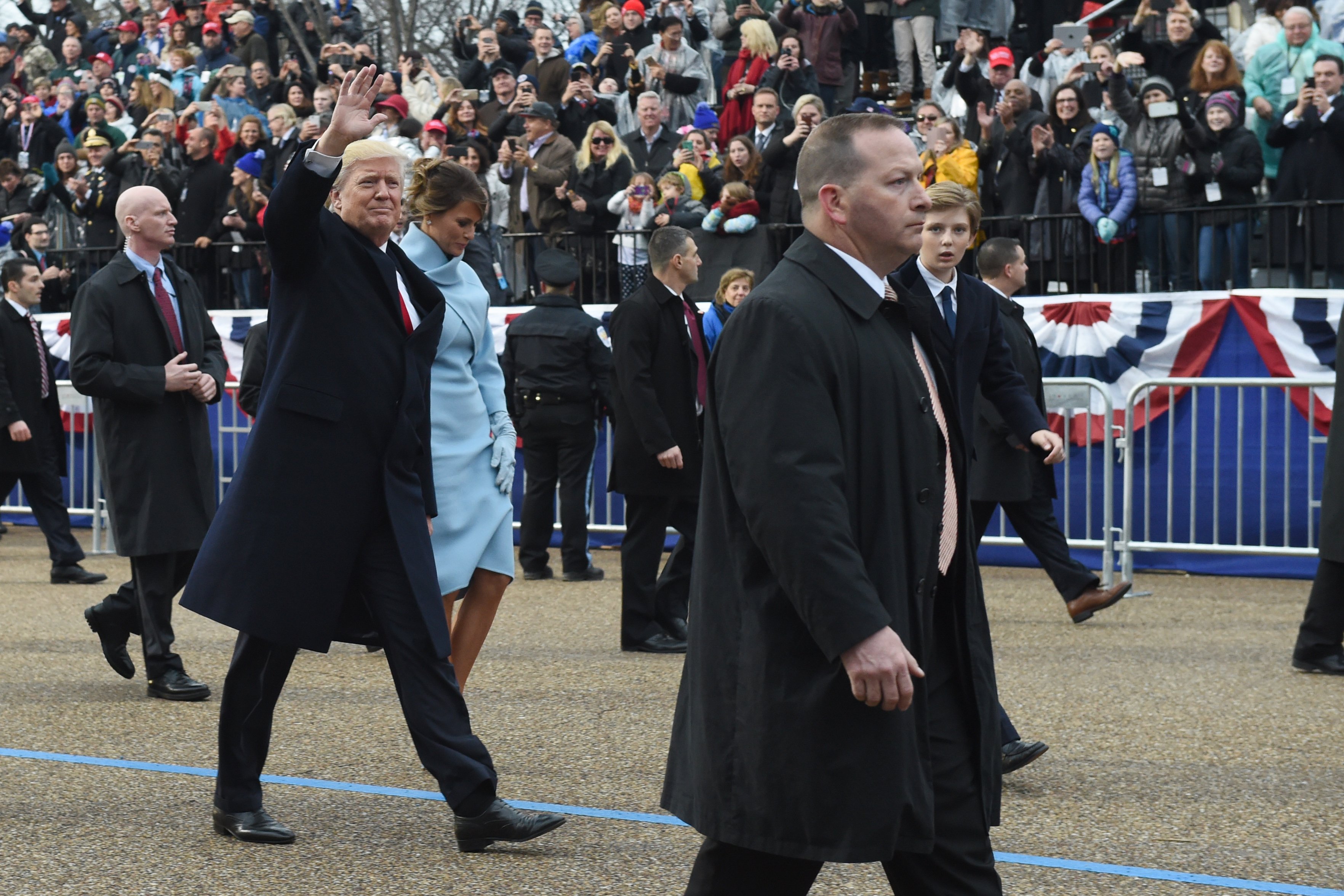 US President Donald Trump walks out of the car with his son Barron (R) and wife Melania surrounded by Secret Service officers at the White House as the presidential inaugural parade winds through the nation's capital on January 20, 2017 in Washington, DC. TIMOTHY A. CLARY/AFP/Getty Images