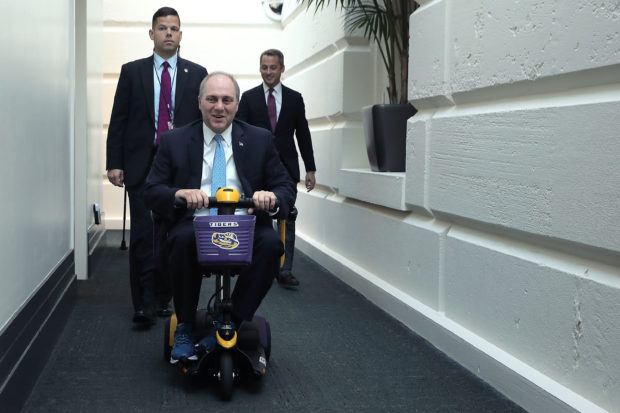 WASHINGTON, DC - OCTOBER 03: House Majority Whip Steve Scalise (R-LA) rides on a Louisiana State University-themed scooter as he arrives for the weekly House GOP conference meeting at the U.S. Capitol October 3, 2017 in Washington, DC. This was Scalise's first conference meeting since being shot during a Congressional sports practice in June. (Photo by Chip Somodevilla/Getty Images)