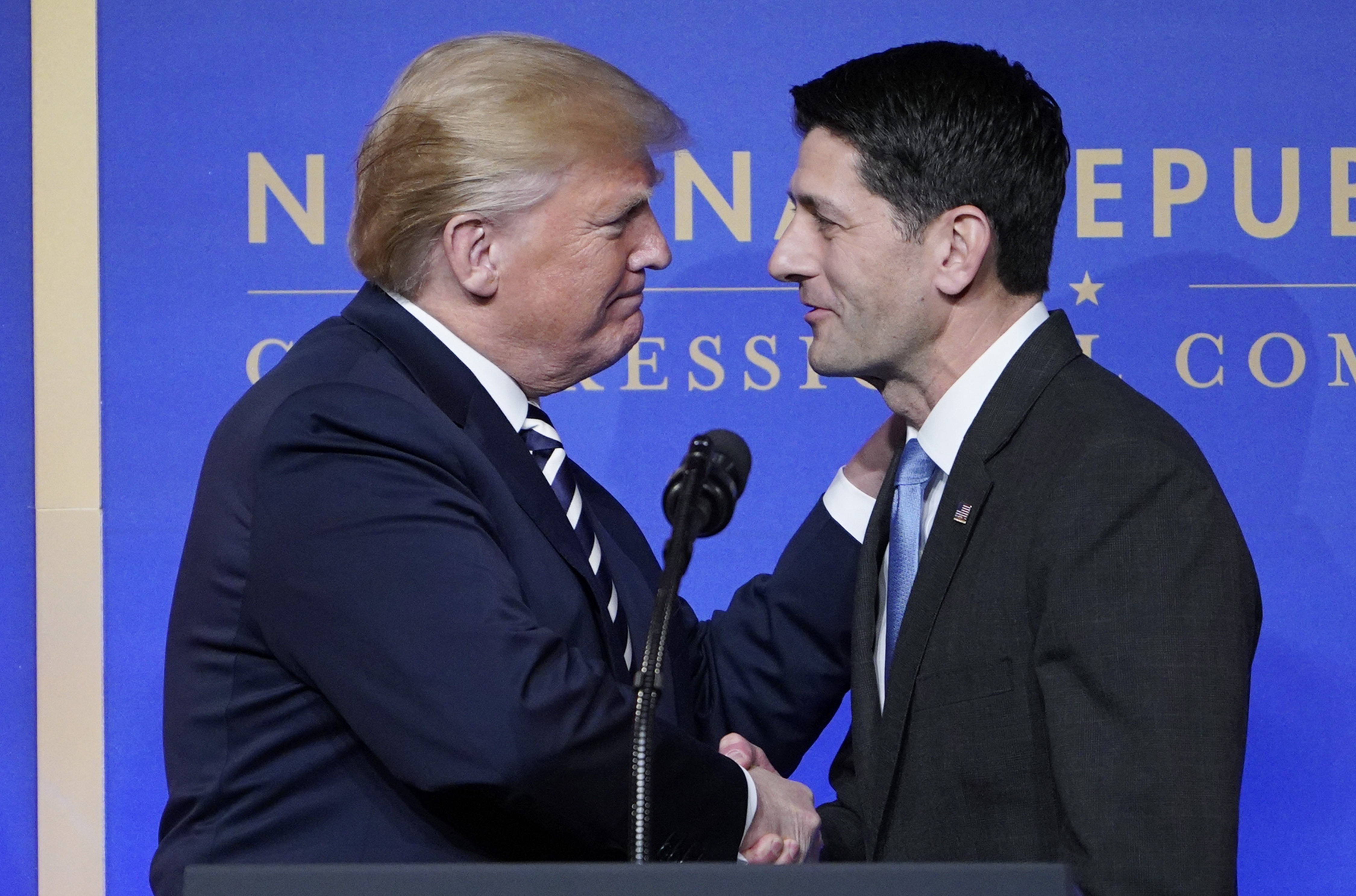 House Speaks Paul Ryan greets US President Donald Trump as he arrives on stage to speak at the National Republican Congressional Committee March Dinner at the National Building Museum on March 20, 2018 in Washington, DC. / AFP PHOTO / MANDEL NGAN (Photo credit should read MANDEL NGAN/AFP/Getty Images)