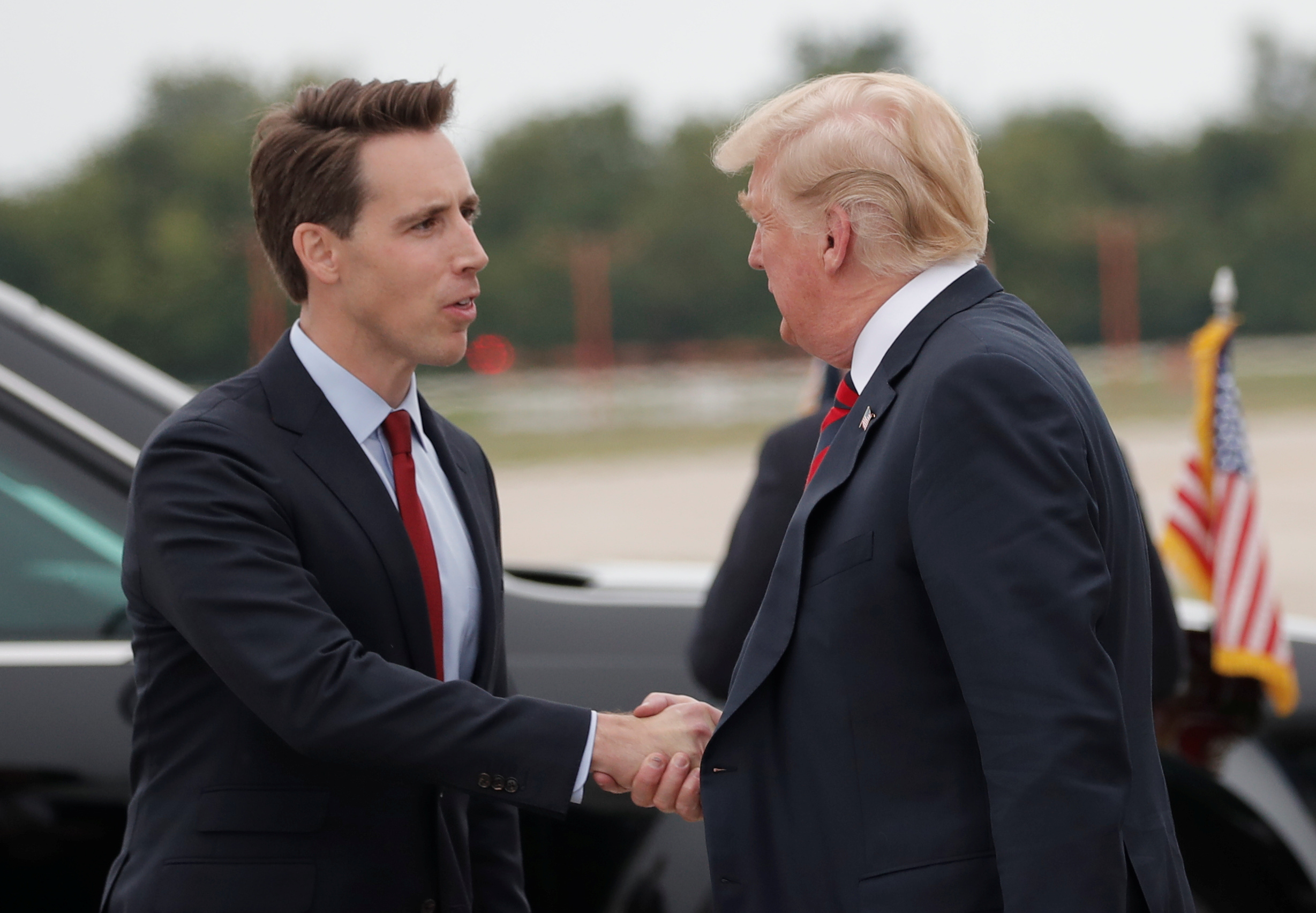 U.S. President Donald Trump shakes hands with U.S. Senate candidate Josh Hawley (L) after arriving in Springfield, Missouri, U.S., September 21, 2018. REUTERS/Mike Segar