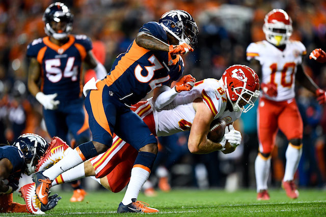 Tight end Travis Kelce #87 of the Kansas City Chiefs is hit by defensive back Will Parks #34 of the Denver Broncos after a catch against the Denver Broncos in the third quarter of a game at Broncos Stadium at Mile High on October 1, 2018 in Denver, Colorado. (Photo by Dustin Bradford/Getty Images)