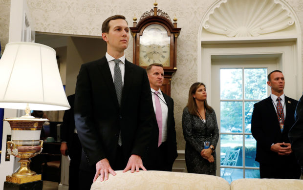 White House senior advisor Jared Kushner listens with other staff members and Secret Service as U.S. President Donald Trump talks to reporters about the killing of journalist Jamal Khashoggi during a bill signing ceremony in the Oval Office of the White House in Washington, U.S., October 23, 2018. REUTERS/Leah Millis
