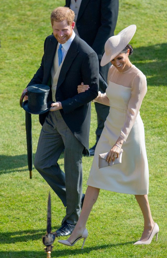Britain's Prince Harry, Duke of Sussex and his new wife Britain's Meghan, Duchess of Sussex, attend the Prince of Wales's 70th Birthday Garden Party at Buckingham Palace in London on May 22, 2018. - The Prince of Wales and The Duchess of Cornwall hosted a Garden Party to celebrate the work of The Prince's Charities in the year of Prince Charles's 70th Birthday. (Photo credit: IAN VOGLER/AFP/Getty Images)