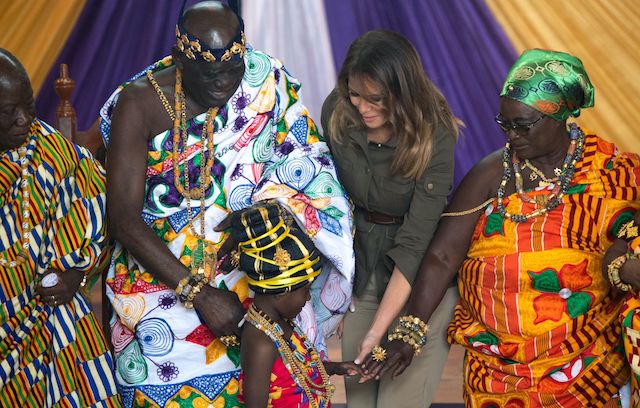 US First Lady Melania Trump poses with Osabarimba Kwesi Atta II, the chieftan of the regional Fante tribe (2ndL), at the Emintsimadze palace in Cape Coast, Ghana, October 3, 2018. - US First Lady Melania Trump is on a solo tour of Africa to promote her children's welfare programme. (Photo credit: SAUL LOEB/AFP/Getty Images)