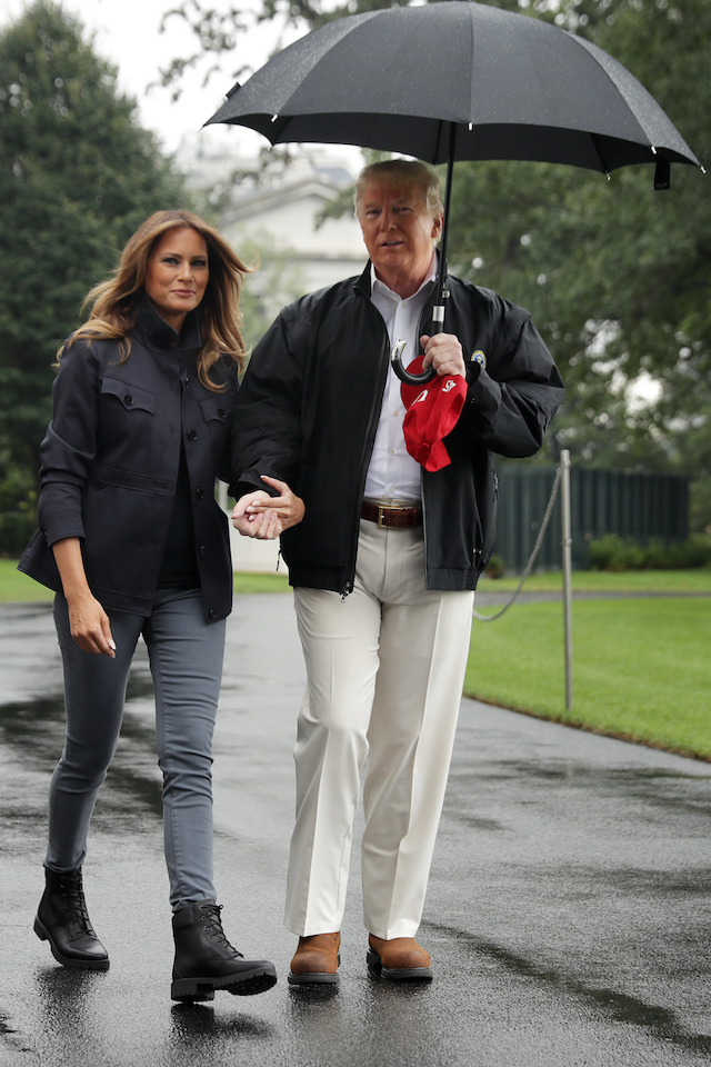 U.S. President Donald Trump and first lady Melania Trump hold hands as they leave the White House October 15, 2018 in Washington, DC. The Trumps are traveling to survey damage from Hurricane Michael, the most powerful storm ever recorded to strike the Florida panhandle. (Photo by Chip Somodevilla/Getty Images)