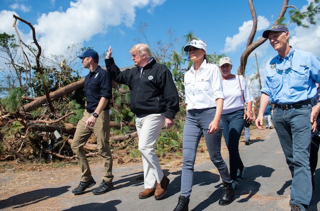 US President Donald Trump, First Lady Melania Trump and Florida Governor Rick Scott(R) tour damage from Hurricane Michael in Lynn Haven, Florida, October 15, 2018. (Photo credit: SAUL LOEB/AFP/Getty Images)