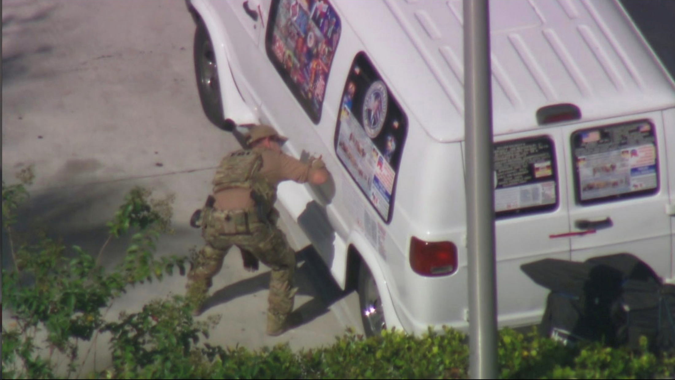 A law enforcement officer checks a van which was seized during an investigation into a series of parcel bombs, in Plantation, Florida October 26, 2018 in a still image fro video. WPLG/Handout via REUTERS