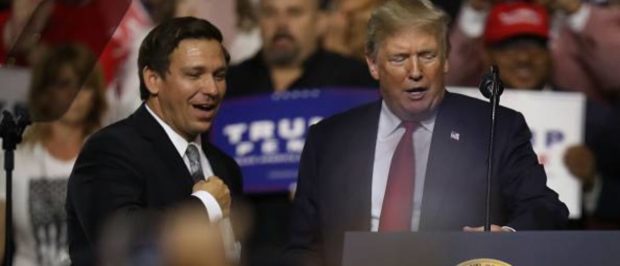 TAMPA, FL - JULY 31: President Donald Trump stands with GOP Florida gubernatorial candidate Ron DeSantis during the president's Make America Great Again Rally at the Florida State Fair Grounds Expo Hall on July 31, 2018 in Tampa, Florida. Before the rally, President Trump visited the Tampa Bay Technical High School for a roundtable discussion on Workforce Development in Tampa. (Photo by Joe Raedle/Getty Images)