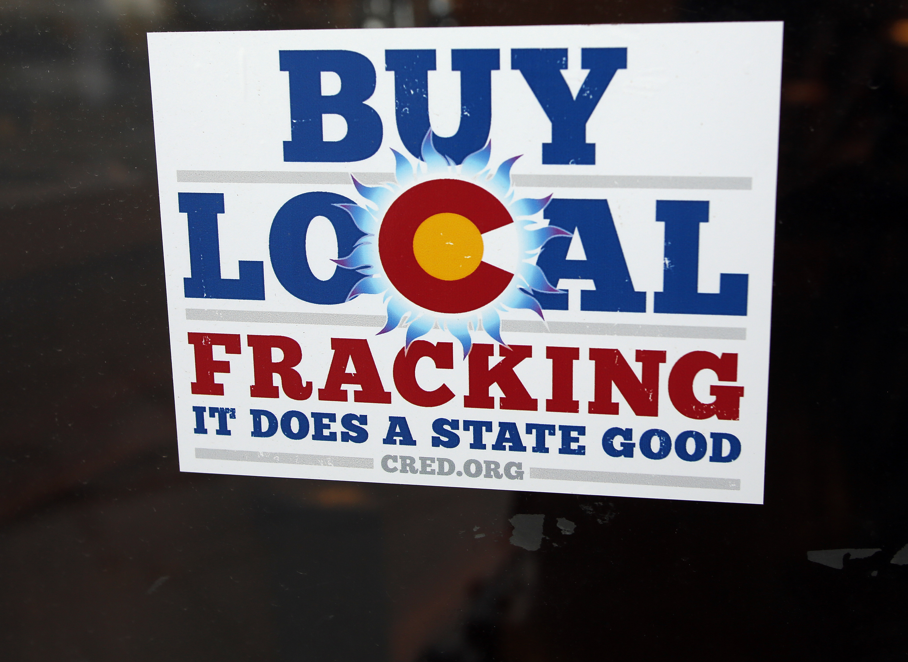 A sign supporting fracking on the doorway at Mama's Restaurant in Parachute, Colorado