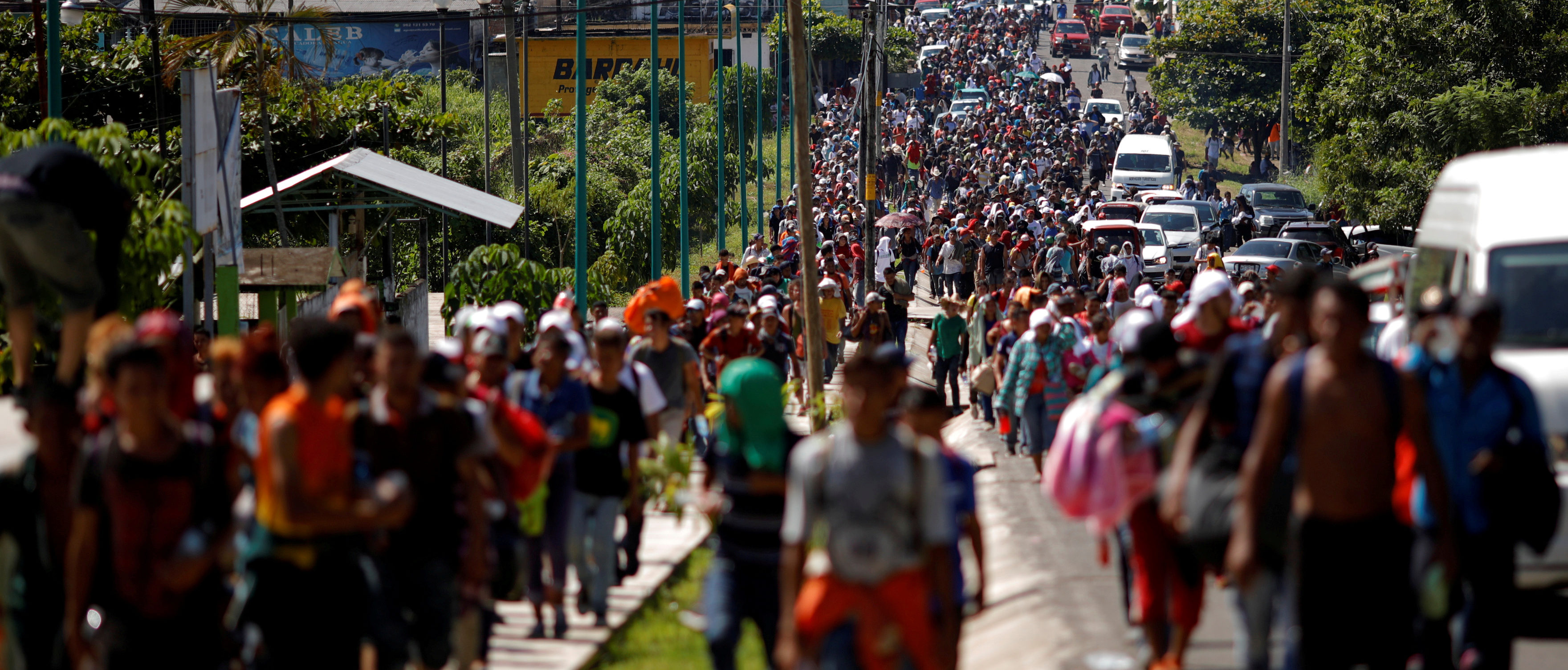 Central American migrants walk along the highway near the border with Guatemala, as they continue their journey trying to reach the U.S., in Tapachula