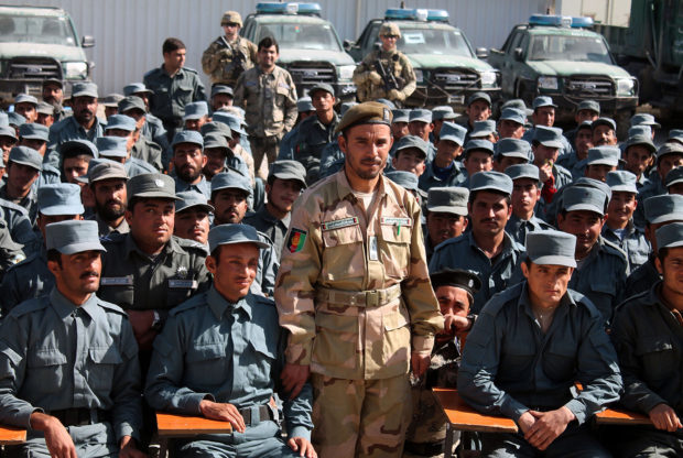 In this photo taken on February 19, 2017, Afghan General Abdul Raziq (C), police chief of Kandahar, poses for a picture during a graduation ceremony at a police training centre in Kandahar province. - An Afghan security chief and a journalist were killed and three Americans wounded on October 18 when a gunman opened fire on a high-level security meeting attended by top US commander General Scott Miller, officials said. JAWED TANVEER/AFP/Getty Images