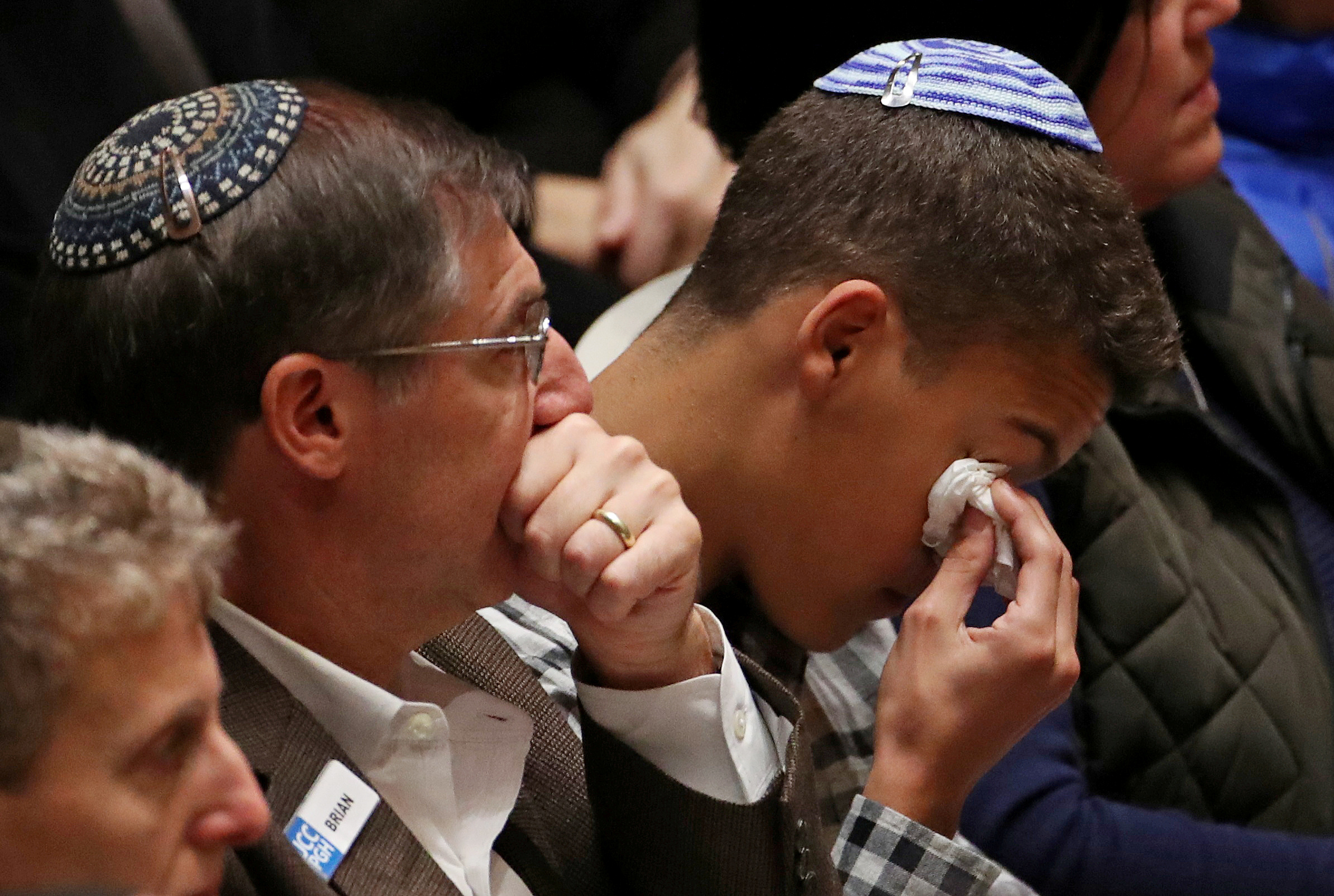 Mourners react during a memorial service at the Sailors and Soldiers Memorial Hall of the University of Pittsburgh, a day after 11 worshippers were shot dead at a Jewish synagogue in Pittsburgh, Pennsylvania, U.S., October 28, 2018. REUTERS/Cathal McNaughton