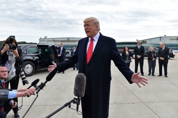 US President Donald Trump speaks with reporters after arriving at Cincinnati Municipal Lunken Airport in Cincinnati, Ohio, on October 12, 2018. - Trump is heading to Lebanon, Ohio, for a "Make America Great Again" rally. (Photo by Nicholas Kamm / AFP) (Photo credit should read NICHOLAS KAMM/AFP/Getty Images