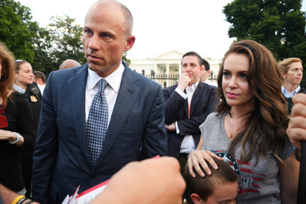 Attorney Michael Avenatti and actor Alyssa Milano attend a protest outside the White House in Washington, U.S. July 17, 2018. REUTERS/Mary F. Calvert