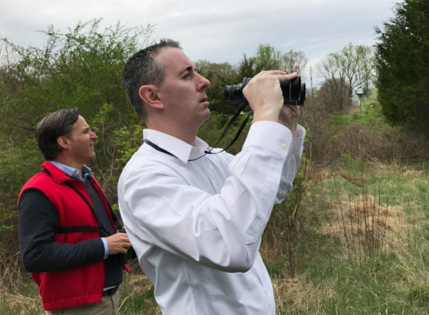 U.S. Rep. Brian Fitzpatrick (R-PA), with Greg Goldman (L), executive director of Audubon Pennsylvania, tries to spot a red-winged blackbird while on a birdwatching tour hosted by the Audubon Pennsylvania in New Hope, Pennsylvania, U.S., April 22, 2017. REUTERS/Emily Flitter