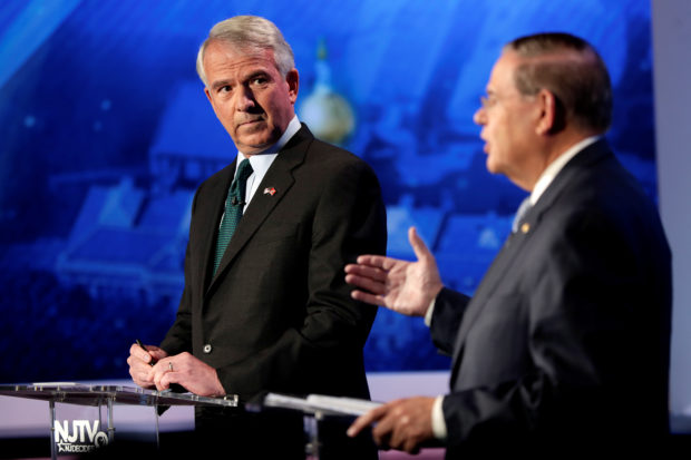 New Jersey Senator Bob Menendez answers a question as Republican Bob Hugin looks on during a debate in Newark, New Jersey. Julio Cortez/Pool via Reuters