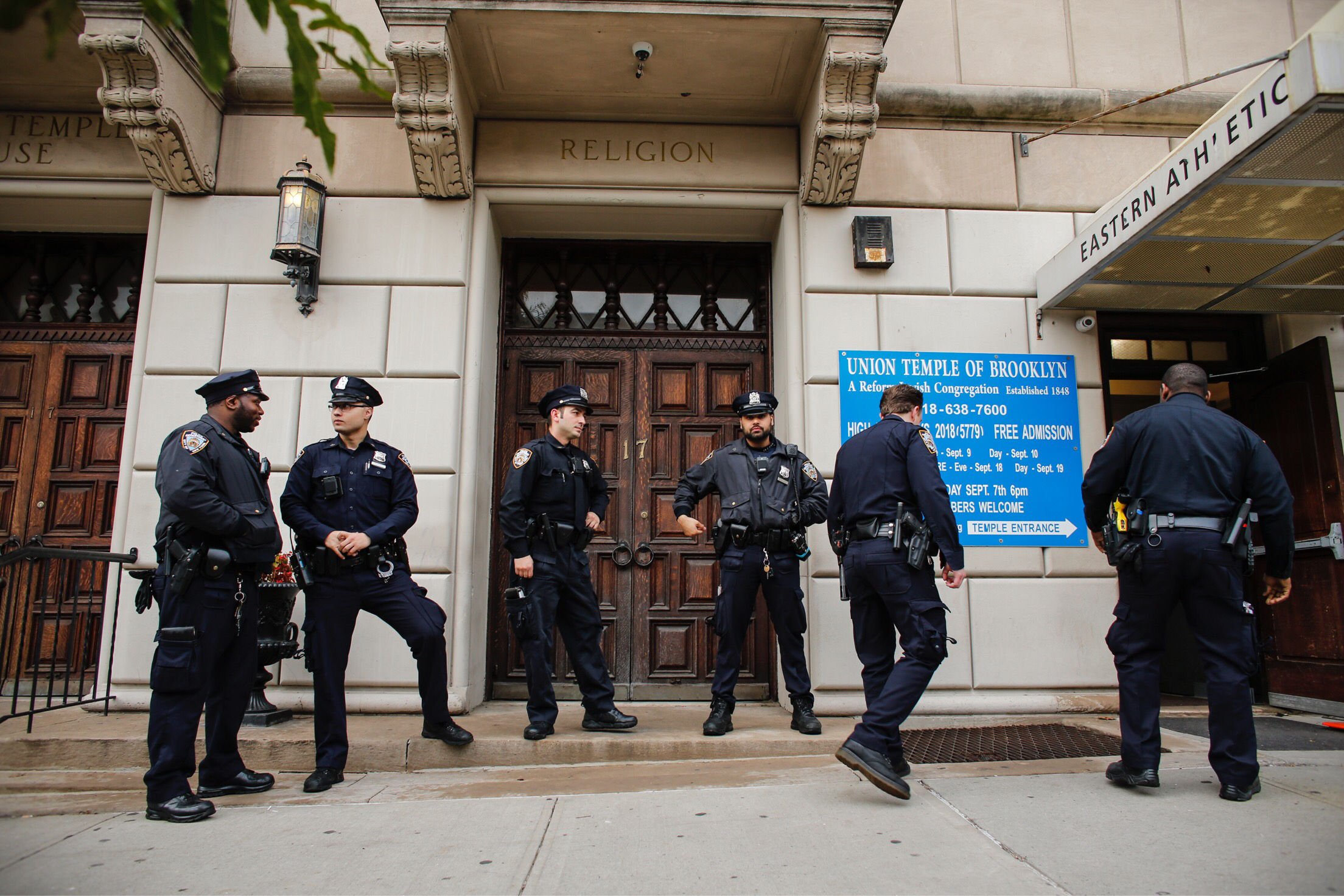 NYPD officers stand guard at the door of the Union Temple of Brooklyn on November 2, 2018 in New York City. - New York police were investigating anti-Semitic graffiti found inside a Brooklyn synagogue that forced the cancellation of a political event less than a week after the worst anti-Semitic attack in modern US history. (KENA BETANCUR/AFP/Getty Images)