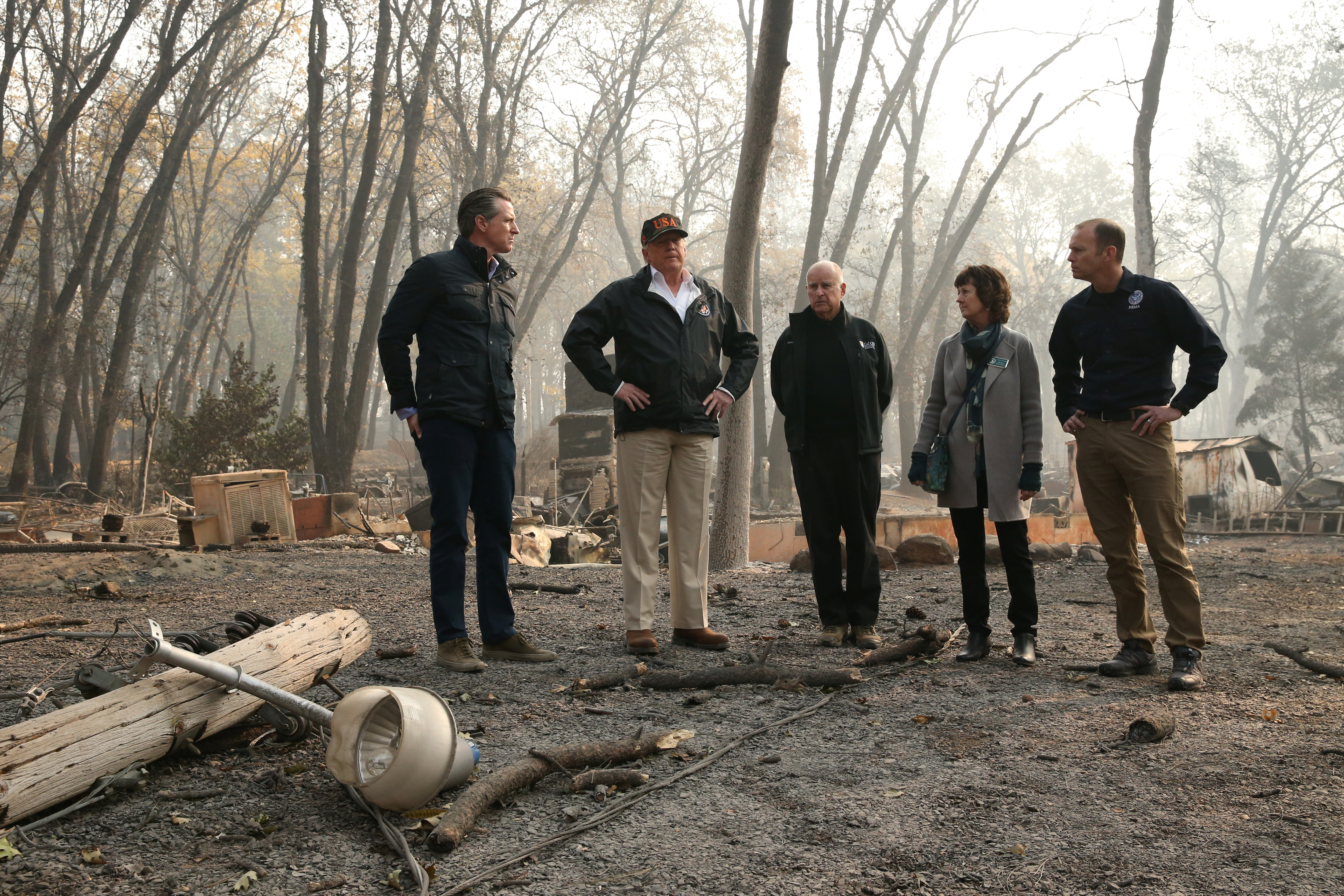 U.S. President Donald Trump visits the charred wreckage of Skyway Villa Mobile Home and RV Park with Governor-elect Gavin Newsom (L), FEMA head Brock Long (R), Paradise Mayor Jody Jones (2nd R) and Governor Jerry Brown in Paradise, California, U.S., November 17, 2018. REUTERS/Leah Millis