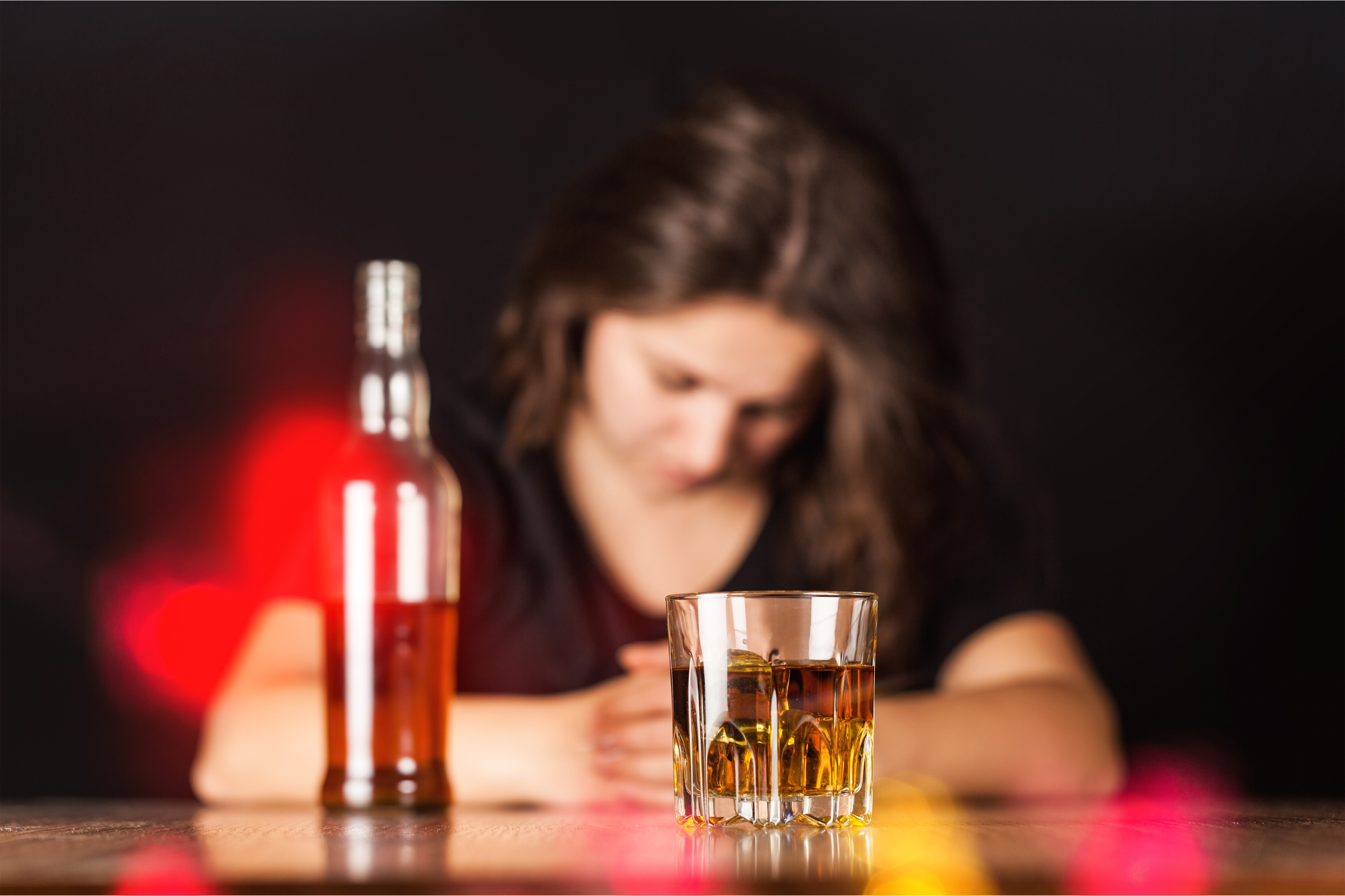 A woman with alcohol. SHUTTERSTOCK/ Billion Photos 