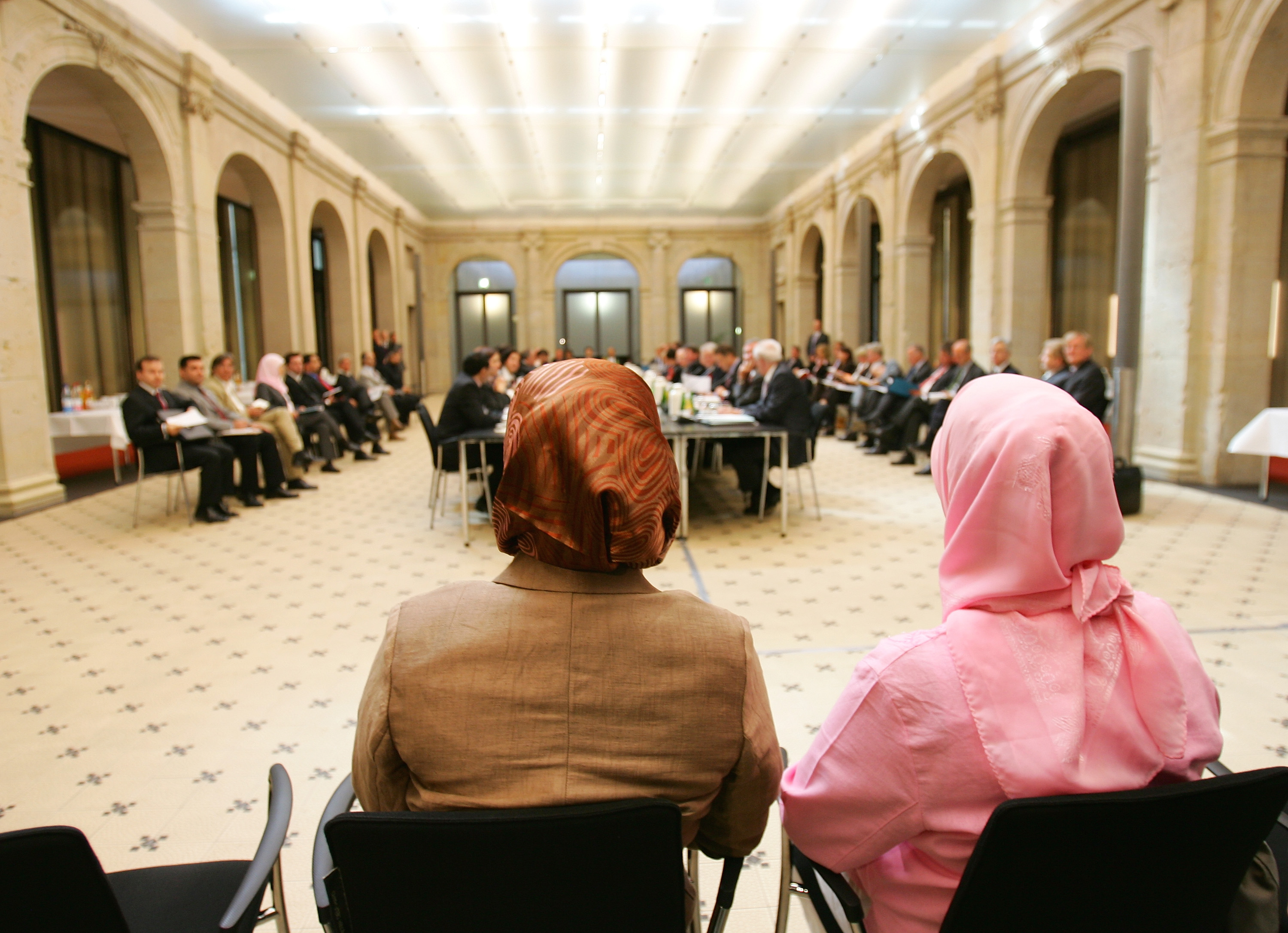 BERLIN - MAY 02: Two Muslim women wearing headscarfs, follow the second conference on Islam on May 2, 2007 in Berlin, Germany. Leading representatives of Germany's three million-strong Muslim community met with German politicians at the conference to discuss topics such as integration, rights and security. (Photo by Andreas Rentz/Getty Images)