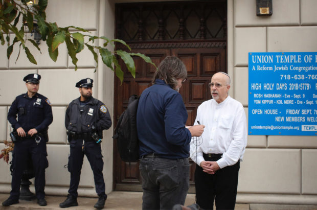 Rabbi Mark Sameth speaks with members of the Media as NYPD officers stand guard at the door of the Union Temple of Brooklyn on November 2, 2018 in New York City. - New York police were investigating anti-Semitic graffiti found inside a Brooklyn synagogue that forced the cancellation of a political event less than a week after the worst anti-Semitic attack in modern US history. (Photo by KENA BETANCUR / AFP) (Photo credit should read KENA BETANCUR/AFP/Getty Images)