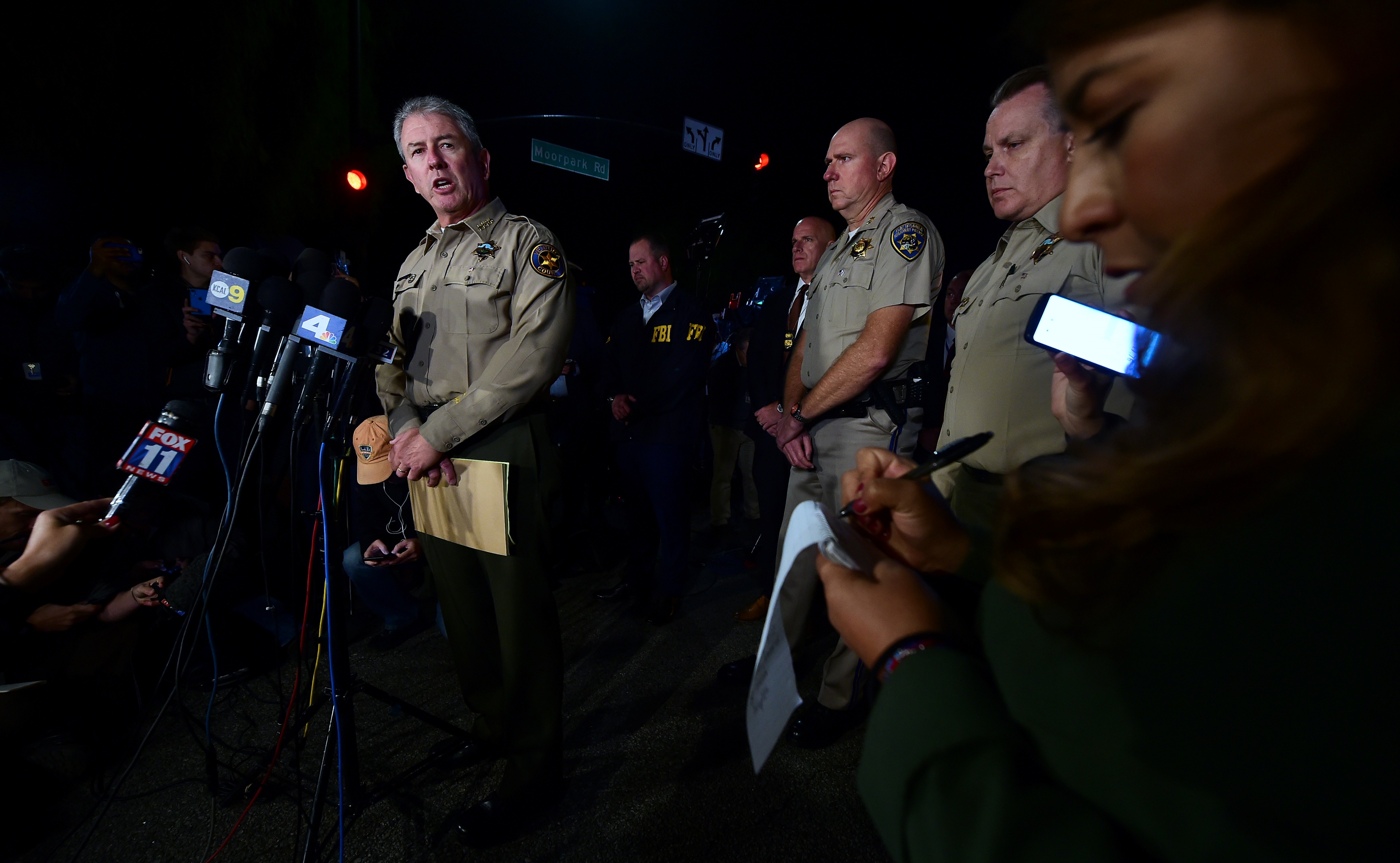 Ventura County Sheriff Geoff Dean briefs reporters at the intersection of US 101 freeway and the Moorpark Rad exit as police vehicles close off the area responding to a shooting at a bar in Thousand Oaks, California on November 8, 2018. - Twelve people, including a police sergeant, were shot dead in a shooting at a nighttclub close to Los Angeles, police said Thursday. All the victims were killed inside the bar in the suburb of Thousand Oaks late on Wednesday, including the officer who had been called to the scene, Sheriff Geoff Dean told reporters. The gunman was also dead at the scene, Dean added. The bar was hosting a college country music night. (Photo by Frederic J. BROWN / AFP) 