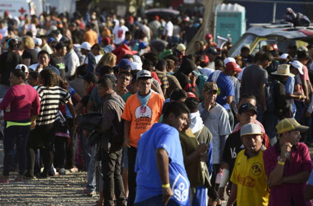 Central American migrants, taking part in a caravan heading to the US, queue to receive a meal at a temporary shelter in Irapuato, Guanajuato state, Mexico on November 11, 2018. - The trek from tropical Central America to the huge capital of Mexico is declining the health of the migrant caravan that endures extreme climate changes, as well as overcrowding and physical exhaustion, and still has to face the desert that leads to the United States. (Photo by ALFREDO ESTRELLA / AFP) (Photo credit should read ALFREDO ESTRELLA/AFP/Getty Images)