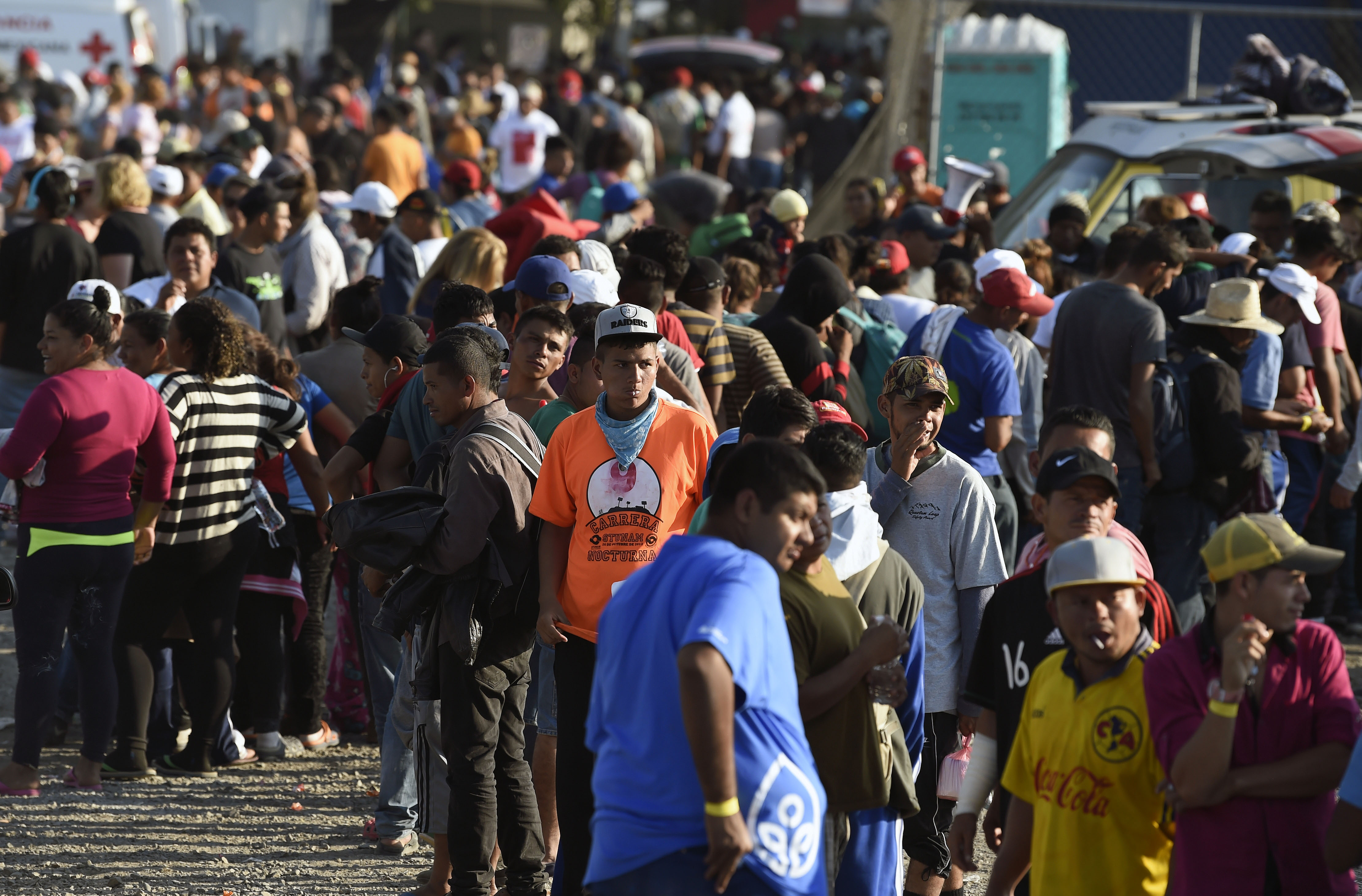 Central American migrants, taking part in a caravan heading to the US, queue to receive a meal at a temporary shelter in Irapuato, Guanajuato state, Mexico on November 11, 2018. (Photo by ALFREDO ESTRELLA / AFP) (Photo credit should read ALFREDO ESTRELLA/AFP/Getty Images)